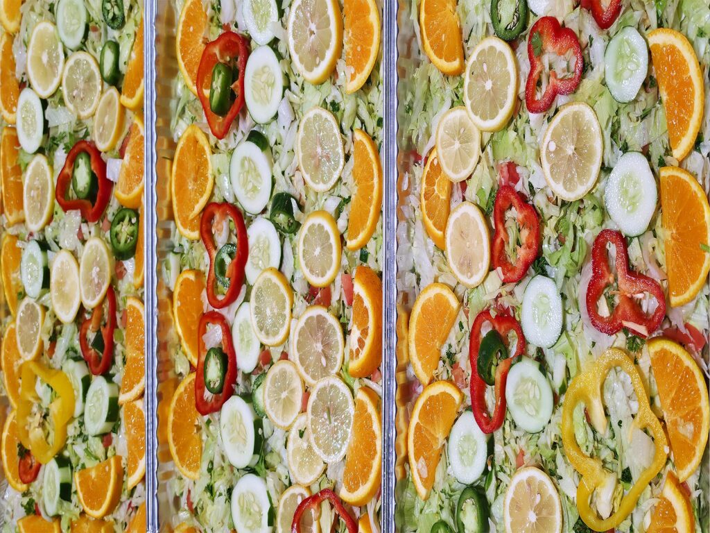 Fresh salad catering trays with oranges, cucumbers and peppers - Marhaba Grill catering, Minneapolis